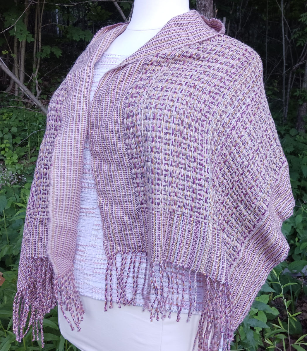 Light lavender alpaca shawl with fringe on a dress form
