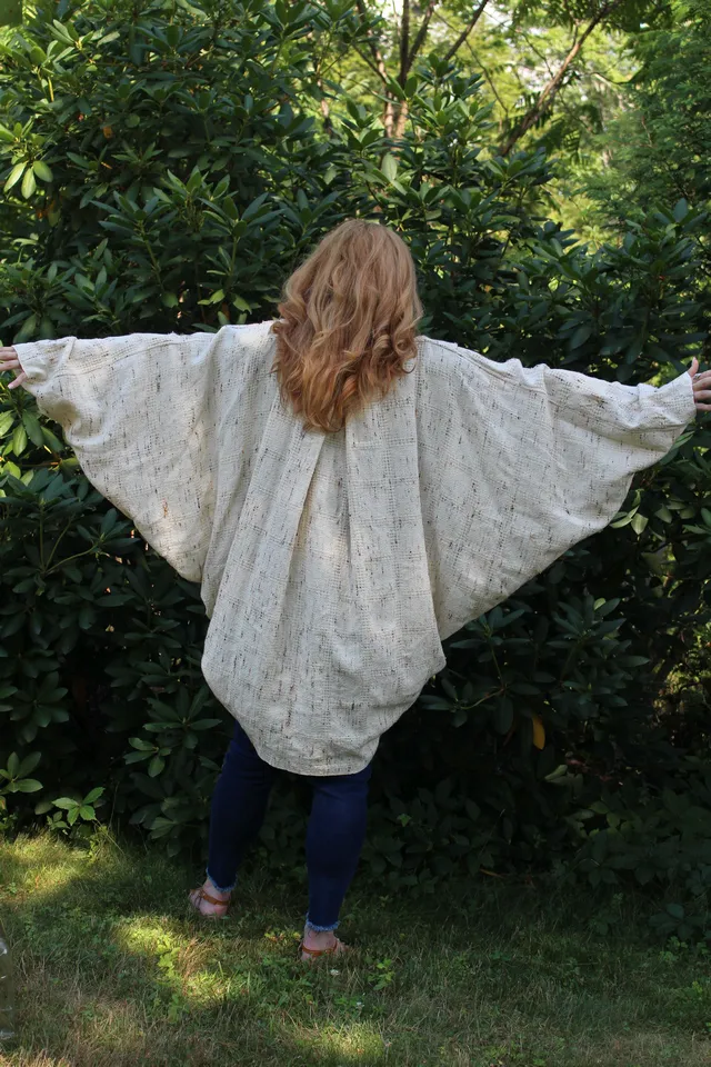 Woman wearing a cream cocoon, back view